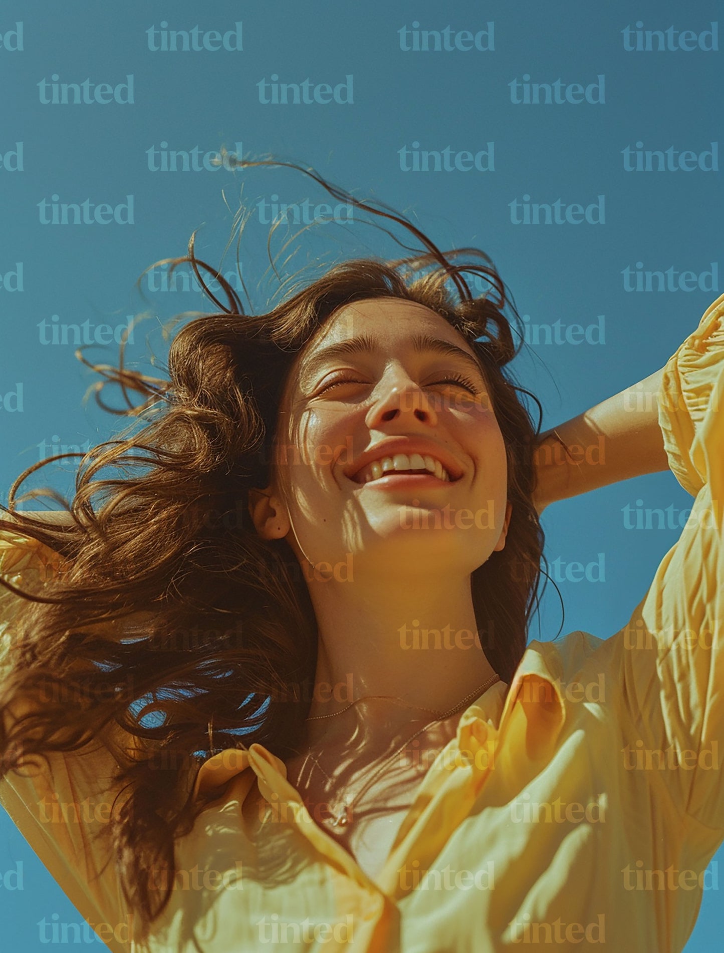 tinted-woman-smiling-with-hand-with-hands-in-her-hair-4789bb3ea26c