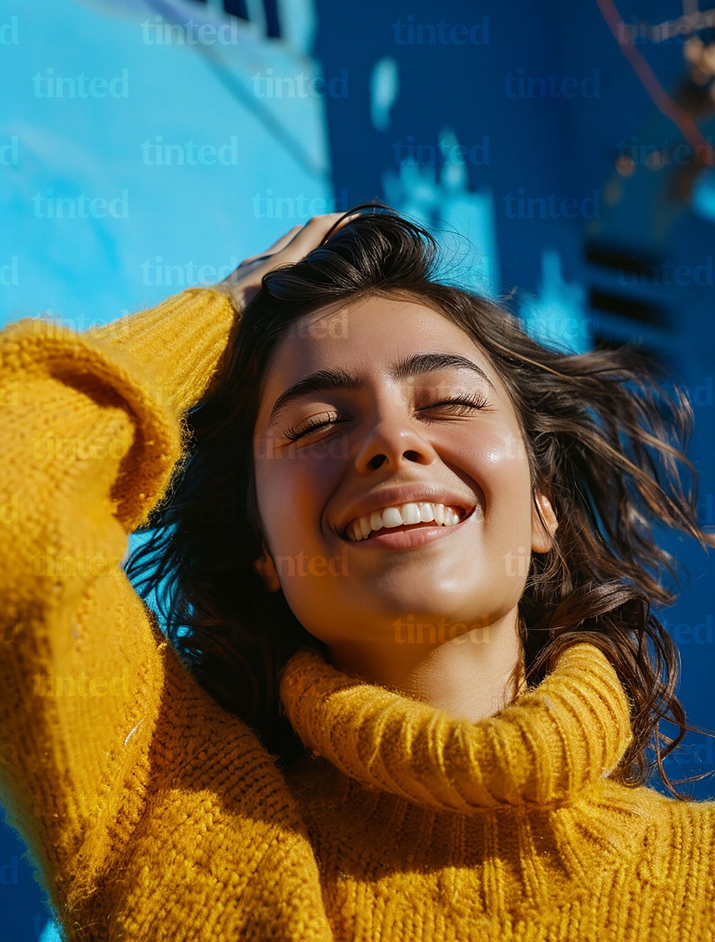 tinted-woman-smiling-with-hand-with-hands-in-her-hair-fcbb743675f9
