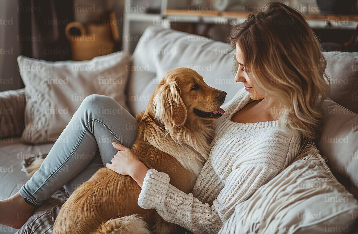 tinted-woman-sitting-on-the-couch-relaxing-and-playing-with-the-dog-00efb63b5dd2