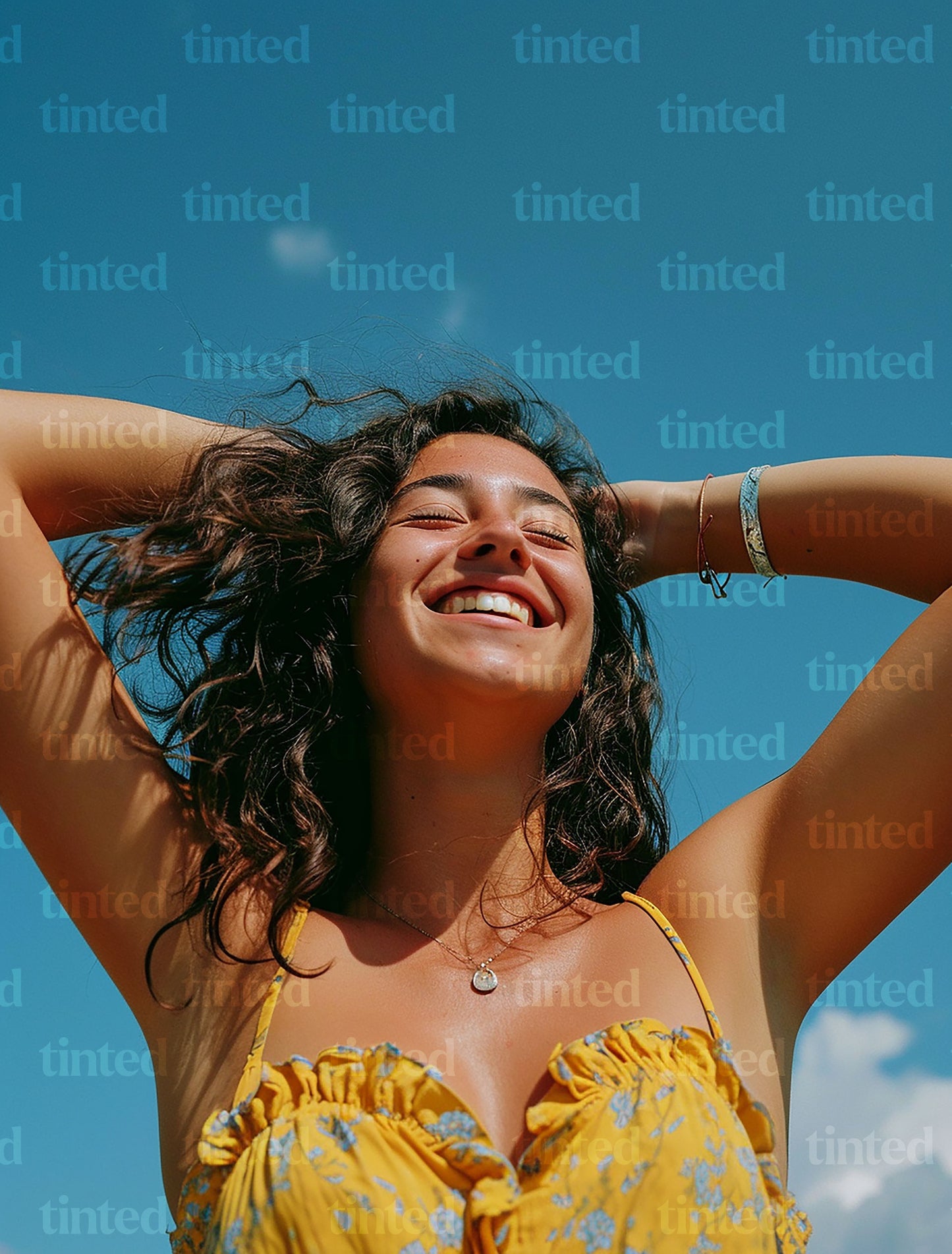 tinted-woman-smiling-with-hand-with-hands-in-her-hair-039d5c557718