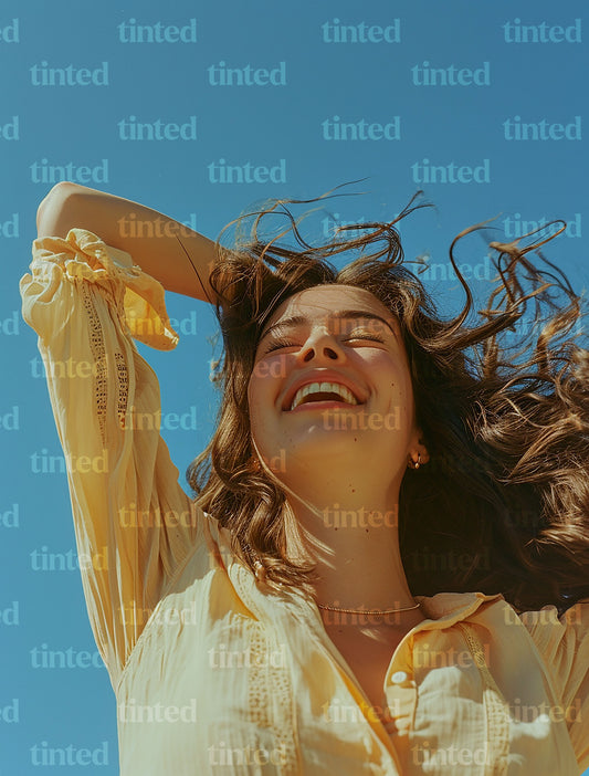 tinted-woman-smiling-with-hand-with-hands-in-her-hair-0a72e60b98f1