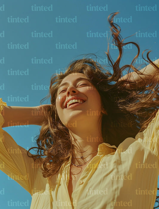 tinted-woman-smiling-with-hand-with-hands-in-her-hair-ed8dcd595971